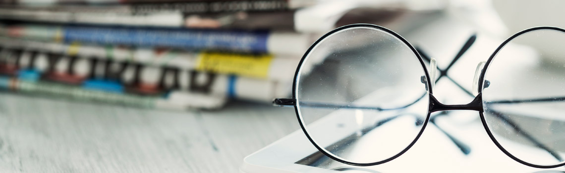 Glasses tablet and newspappers