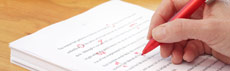 Person doing proofreading with red pen
